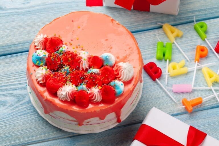 Birthday cake, gift boxes and happy birthday candles
